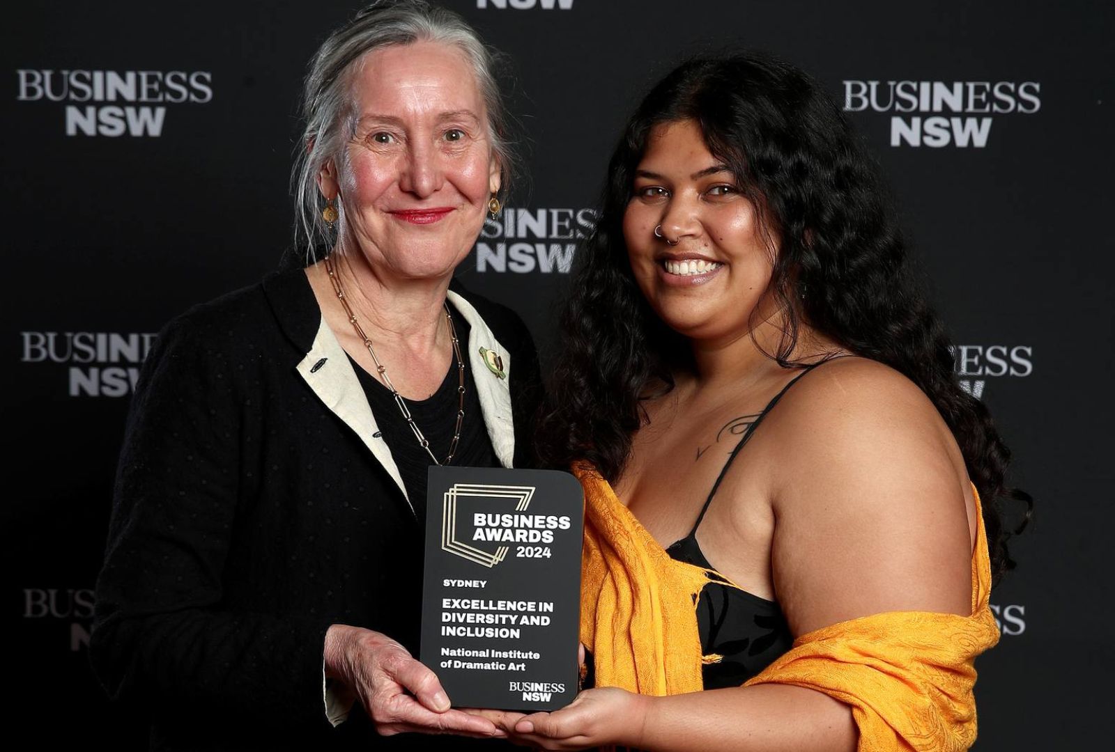 From left to right: Christina Alvarez and Andrea Daniels accepted the award for Excellence in Diversity and Inclusion on behalf of NIDA at the Business Awards 2024.