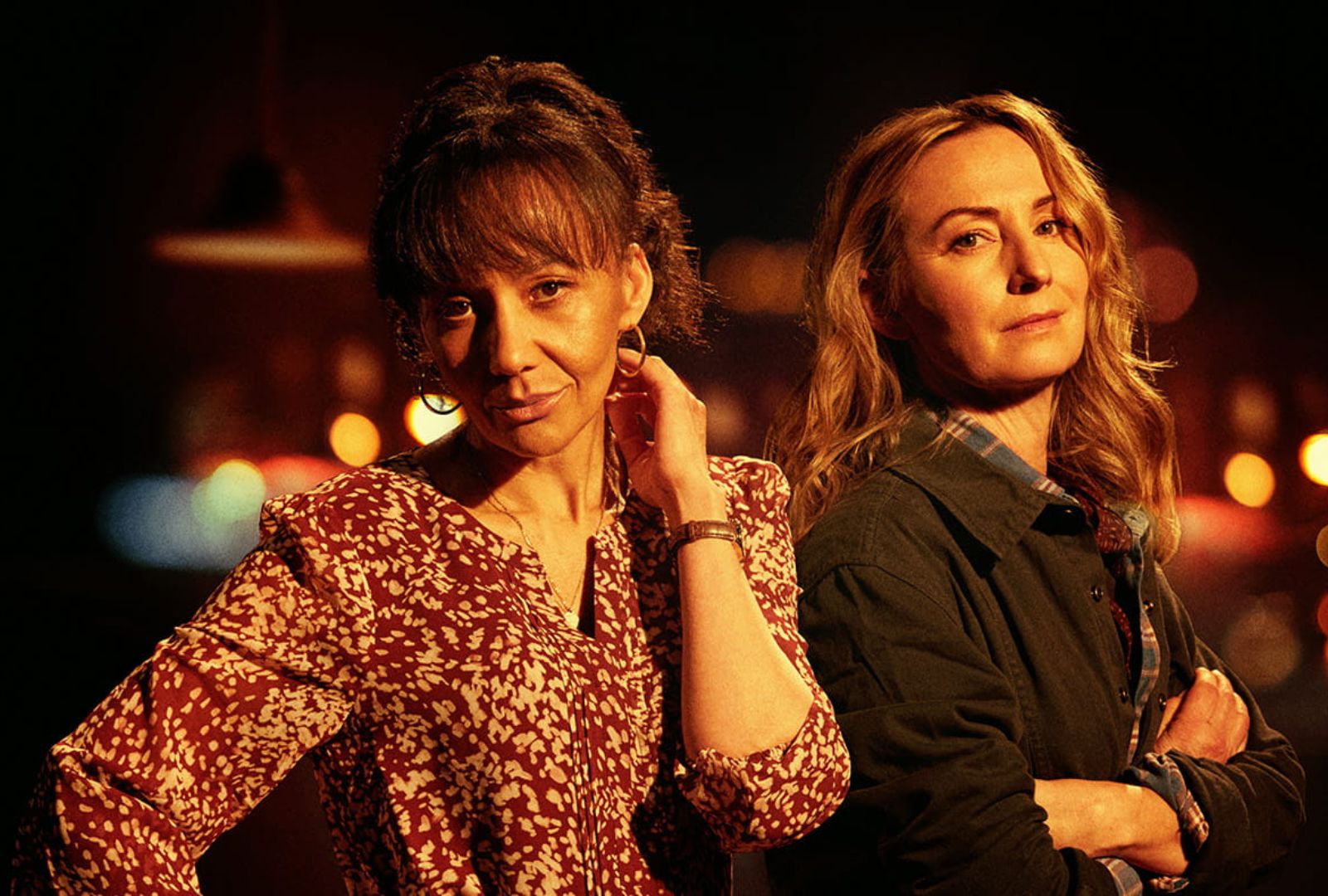 Paula Arundell and Lisa McCune in Sydney Theatre Company's 'Sweat'. They look at the camera smirking and posed casually.