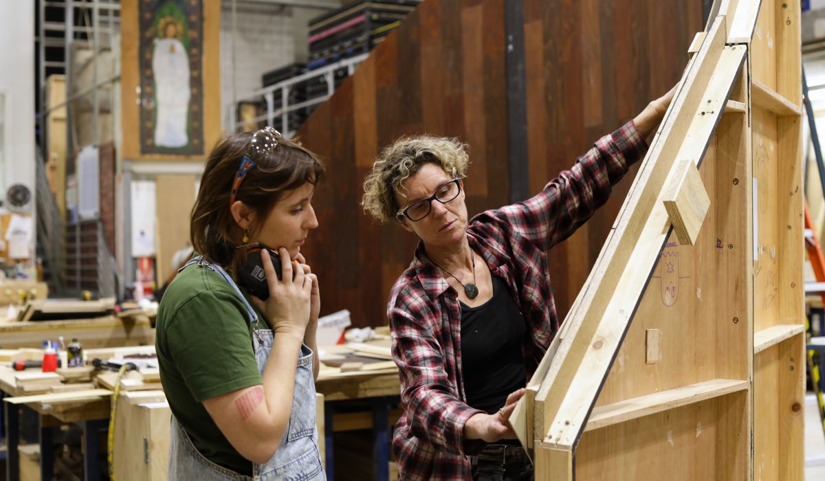 Lynsey Brown senior lecturer in Scenic Construction and Spring Awakening construction manager Hannah Garman discuss timber choices in the NIDA workshop.