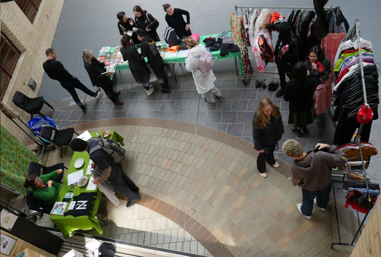 Staff and students looking through pre-loved goods in the NIDA atrium.